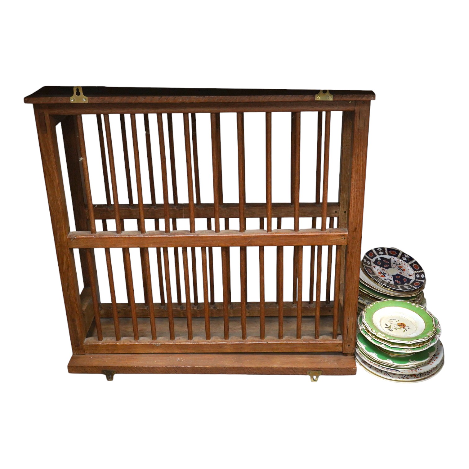 A teak plate rack with sundry antique plates. Condition - varies